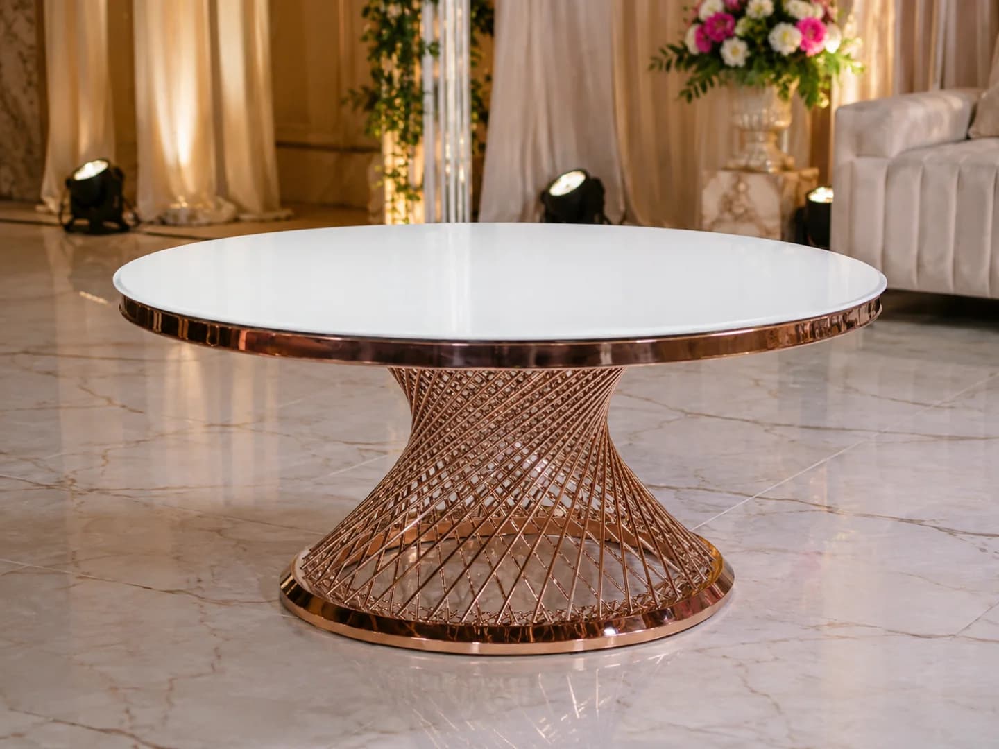 Round white-top banquet table with a rose gold lattice base