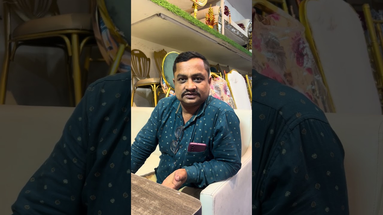 Customer seated on a white sofa giving a video testimonial at the TentMart showroom